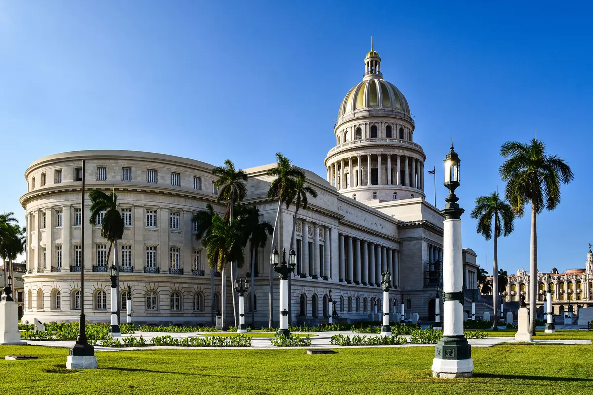 El Capitolio with palm trees under a blue sky